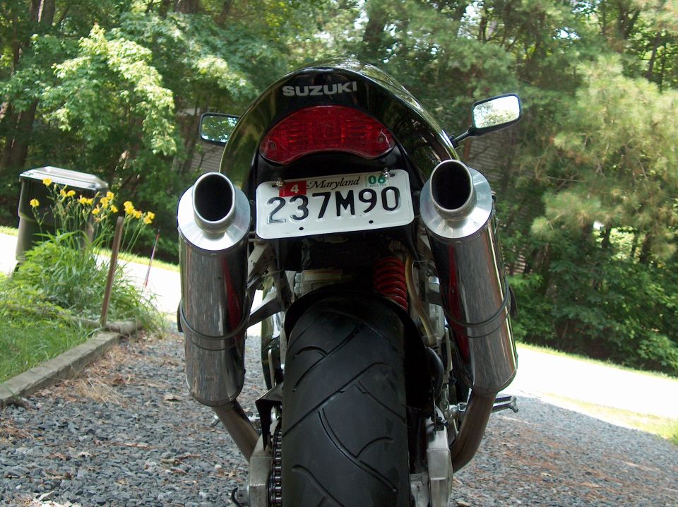 Rear view of a motorcycle with dual exhaust pipes and a Maryland license plate reading 237M90