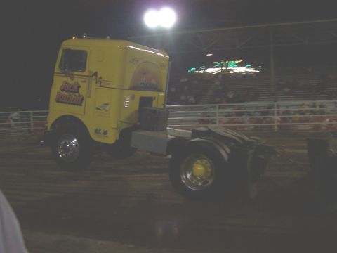 1994 Ford F-150 - A yellow semi-truck cab, identified as 'Jack Rabbit', is seen at an outdoor event at night.