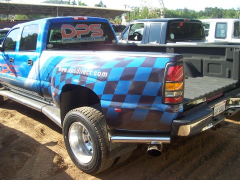 1994 Ford F-150 - A custom-wrapped pickup truck is parked outdoors, with another vehicle visible behind it.