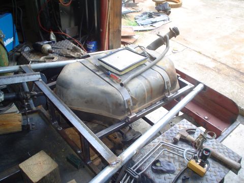 1981 Ford Bronco - A fuel tank and air filter are mounted on a metal frame, with various tools scattered around.