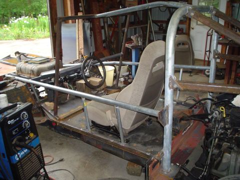 1981 Ford Bronco - This custom build features a roll cage and bucket seat, indicating a project in progress.