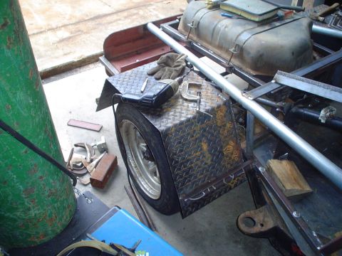 1981 Ford Bronco - A custom trailer frame is under construction, with tools and a fuel tank visible.