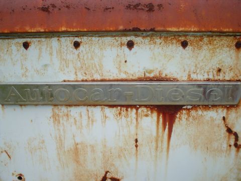 1981 Ford Bronco - The Autocar-Diesel emblem is visible on a weathered and rusty vehicle body.