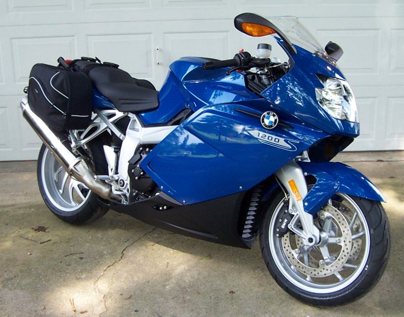 Blue BMW K1200S sport motorcycle parked on driveway, front 3/4 view