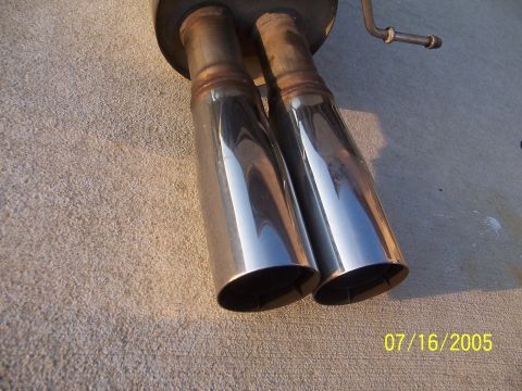 1994 Ford Probe - Dual chrome exhaust tips are shown against a concrete surface, with a date stamp of 07/16/2005.