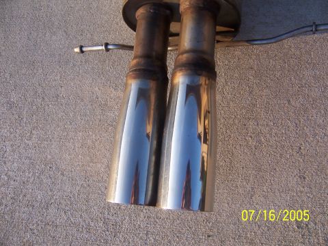 1994 Ford Probe - Dual exhaust tips are shown against a concrete background with a date stamp of 07/16/2005.