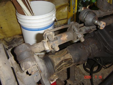 1993 Ford Bronco - Close-up view of vehicle steering and axle components, showing signs of wear and rust.