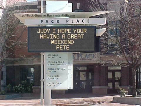 1988 Ford Bronco - A digital sign at Pack Place displays a personal message, with building and trees in the background.