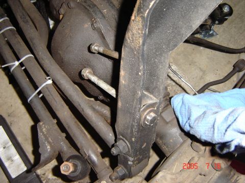 1993 Ford Bronco - Close-up view of the front axle and steering components, with a blue cloth partially obscuring the view.