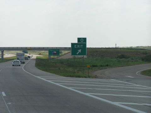 1993 Ford Taurus - A highway scene shows an exit sign and a sign with the Texas flag, indicating a route.
