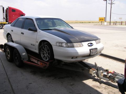 1993 Ford Taurus - 1993 Ford Taurus being transported on a U-Haul trailer.