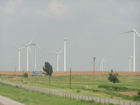 1993 Ford Taurus - A row of wind turbines stands tall in a field, with a road and a sign indicating Exit 804.