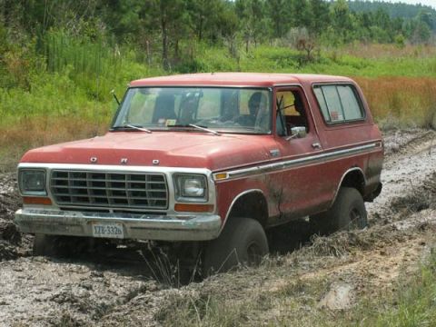 1988 Ford Bronco - Red 1978 Ford Bronco is stuck in the mud off-road.
