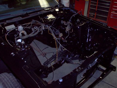1970 Ford Ranchero - The engine bay is black and shows exposed wiring, suggesting it's in the process of being worked on.