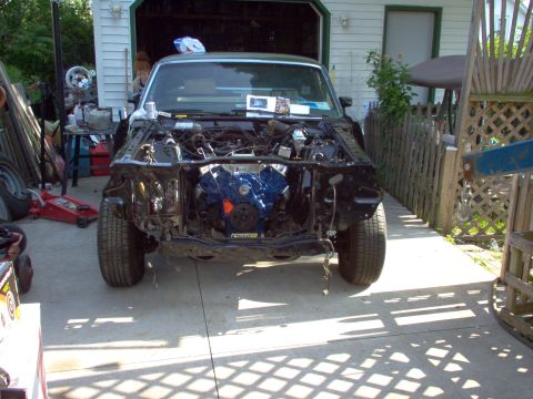 1970 Ford Ranchero - This 1970 Ford Ranchero is in a state of disassembly, with its engine bay open and components missing.