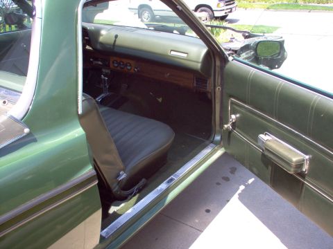 1970 Ford Ranchero - Interior view of a green 1970 Ford Ranchero, showing the dashboard and driver's seat.