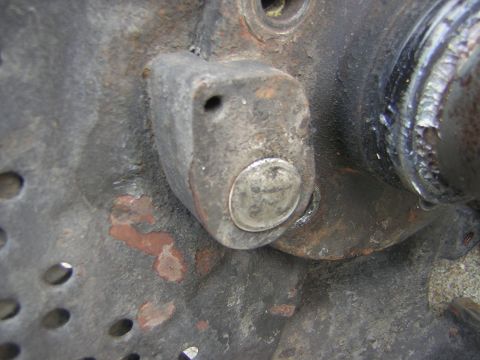 1995 Ford Bronco - Detail of a worn metal component, showing rust and a bolt head.