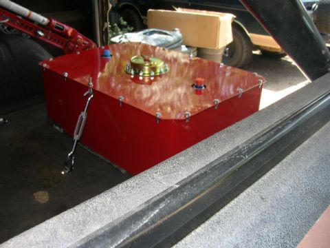 1995 Ford Bronco - A large red fuel tank is secured inside a vehicle, with a roll cage visible in the foreground.