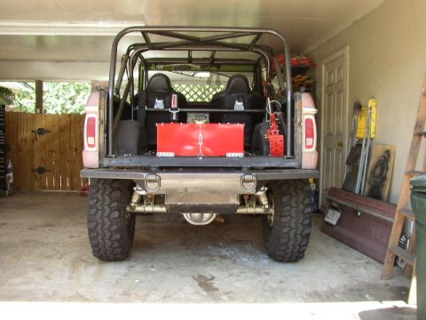 1995 Ford Bronco - Rear view of a heavily modified Ford Bronco with a roll cage and racing seats.