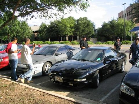 1994 Ford Probe - Two Ford Probes are parked side-by-side in a parking lot with people nearby.