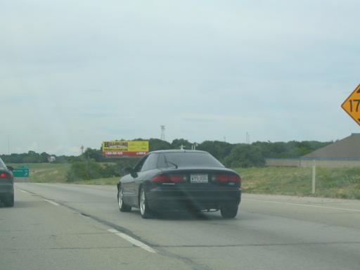 Black 1994 Ford Probe rear view on highway