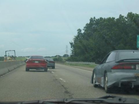 1994 Ford Probe - Two cars driving on a highway, one appears to be a 1994 Ford Probe.