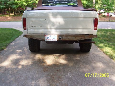 1979 Ford Bronco - This Ford Bronco features a custom rear bumper and a soft top, seen from the back.