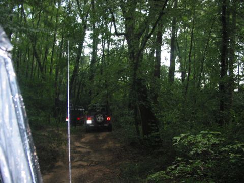 2000 Jeep Grand Cherokee - Off-roading through a wooded area with two vehicles on a dirt trail.