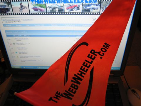 1990 Ford Bronco - red TheWebWheeler.com decal lies across a laptop displaying the forum's search-results page.