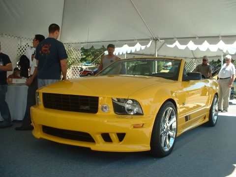 1999 Ford Crown Victoria - Yellow convertible sports car on display at an outdoor event.