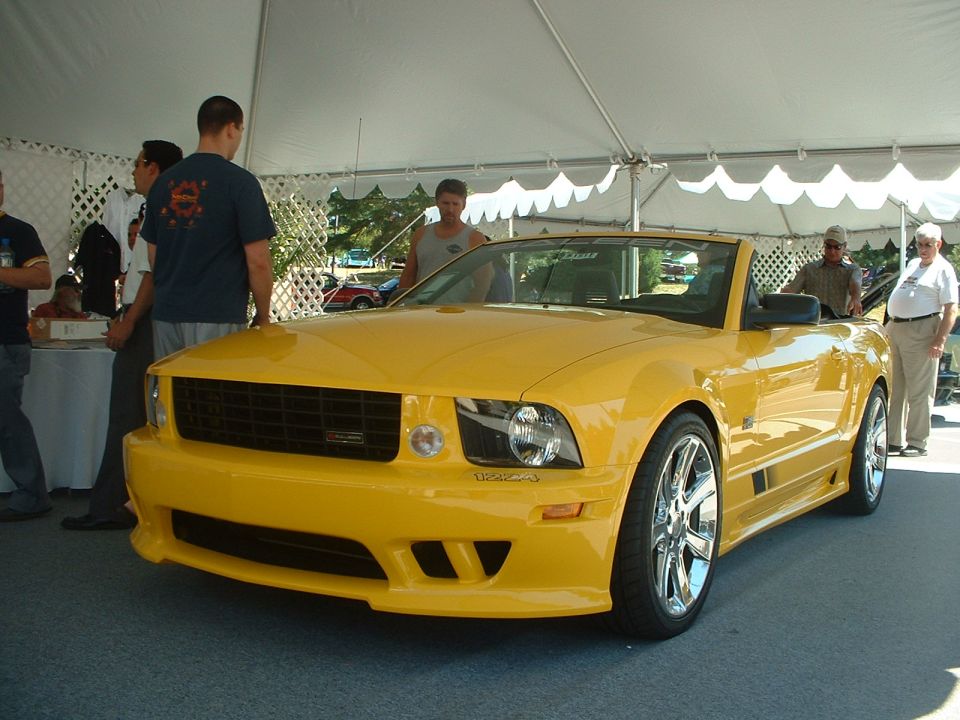 Yellow convertible sports car with custom grille and wheels