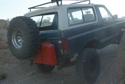1986 Ford Bronco - This Ford Bronco is equipped for off-road adventures with a roof rack and extra fuel containers.