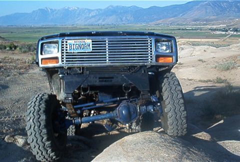 1986 Ford Bronco - This heavily modified Ford Bronco features a custom grille and off-road tires, suggesting it's built for terrain.