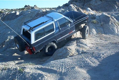 1986 Ford Bronco - This 1986 Ford Bronco navigates challenging rocky terrain, its off-road capabilities.