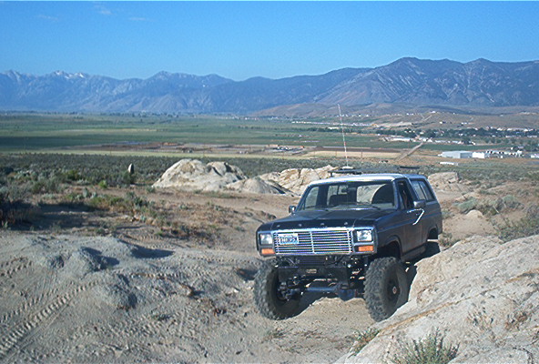 Black 1980s Ford Bronco on rocky terrain
