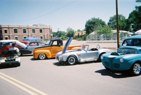1972 Ford Ranchero - A collection of vintage vehicles and a golf cart are displayed outdoors on a sunny day.