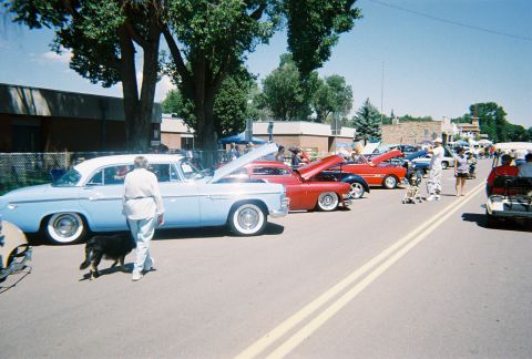 1972 Ford Ranchero - A sunny day car show features a line of vintage vehicles with their engines exposed for viewing.