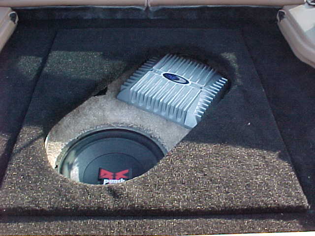 Car audio amplifier and subwoofer installed in a trunk
