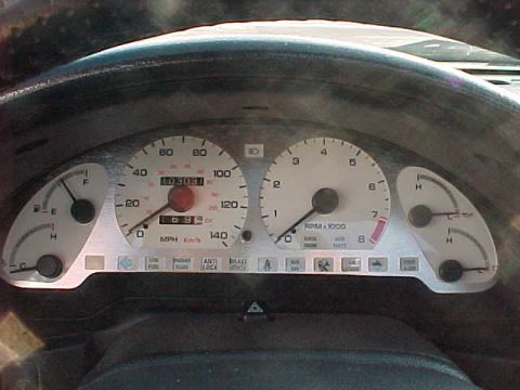 1993 Ford Probe - The interior of a 1993 Ford Probe shows its instrument cluster, including the speedometer and tachometer.