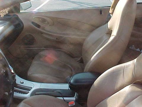 1993 Ford Probe - Interior view of a car's tan leather seats and dashboard.