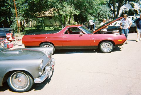 1972 Ford Ranchero - Two classic American cars, a red 1972 Ford Ranchero and a silver Ford Thunderbird, at an outdoor event.