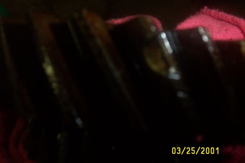 1979 Ford F-150 - A close-up view of a dark, oily gear with distinct teeth, partially covered by a red cloth.