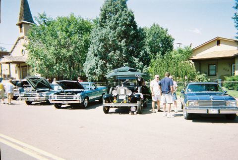 1972 Ford Ranchero - Several classic vehicles are displayed outdoors, with people milling around them.