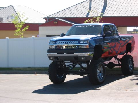 1991 Ford Bronco - This heavily modified pickup truck features a prominent lift kit and custom graphics on its side panels.