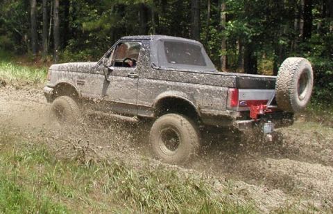 1988 Ford Bronco - This 1988 Ford Bronco is shown kicking up mud as it navigates a trail.