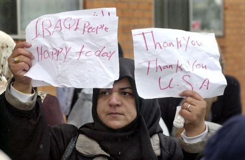 1983 Ford F-250 - A woman holds signs expressing thanks to the USA and happiness for Iraqi people.