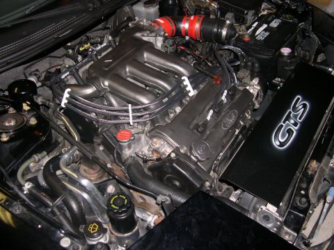 1997 Ford Probe - The engine bay of a 1997 Ford Probe shows its V6 engine with a black GTS air intake cover.