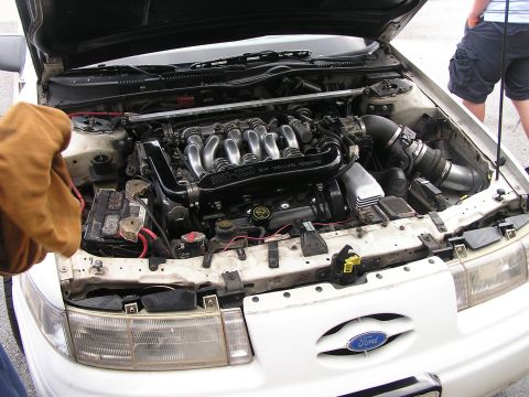 1993 Ford Taurus - Engine bay of a 1993 Ford Taurus SHO, showing the V6 engine and associated components.