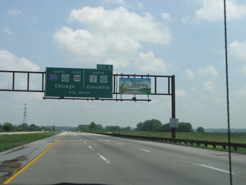 1993 Ford Taurus - Driving on a highway with overhead signs indicating directions to Chicago and Columbia, and an advertisement for Illinois.