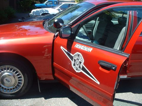 1999 Ford Crown Victoria - This 1999 Ford Crown Victoria, marked as State Patrol, is shown with its driver's door ajar, revealing the interior.